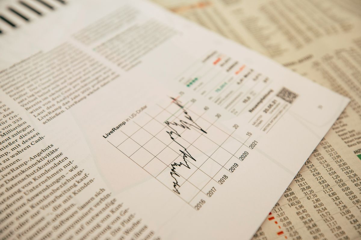 Oopensteps; Close-up of financial reports and charts being reviewed on a desk.